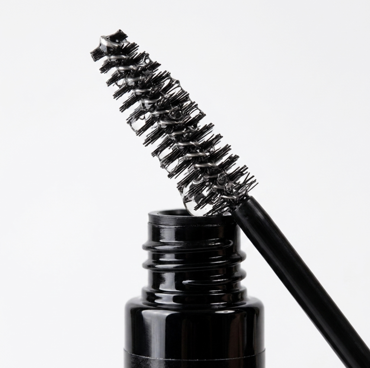 Applying Elleeplex Hyaluronic Boost Serum spoolie brush onto natural lashes and brows for deep daily hydration.