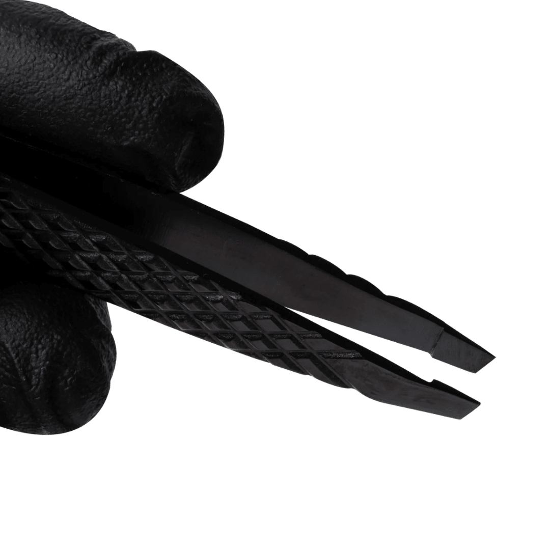 Professional brow technician using Elleebana Ellee-Brow tweezers to pluck fine eyebrow hairs.