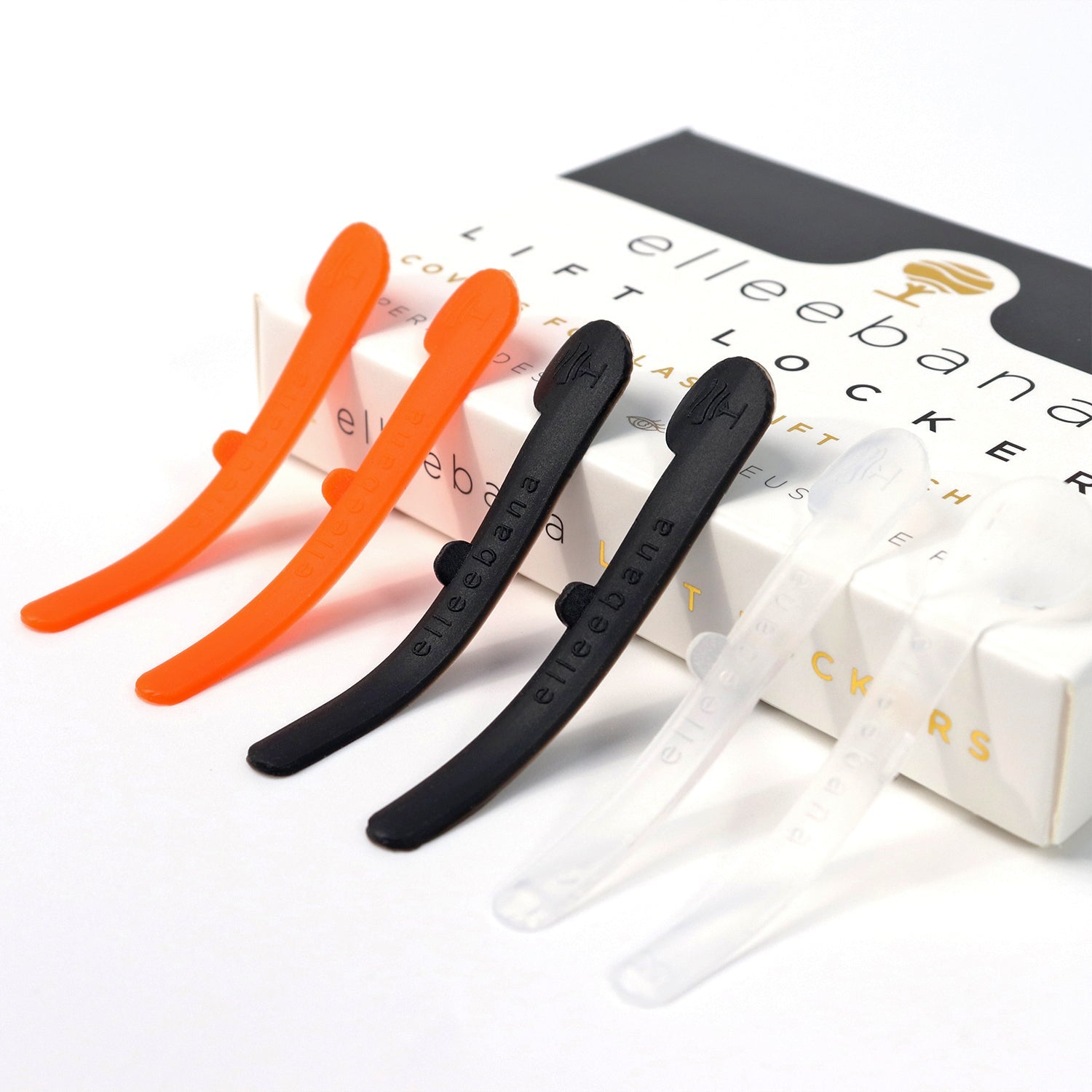 Set of Elleebana Lift Lockers soft silicone covers in orange, clear, and black for securing lash lifts.