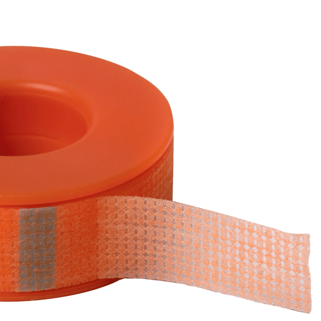 Close-up view of the breathable, easy-tear orange silicone tape texture designed for sensitive skin.