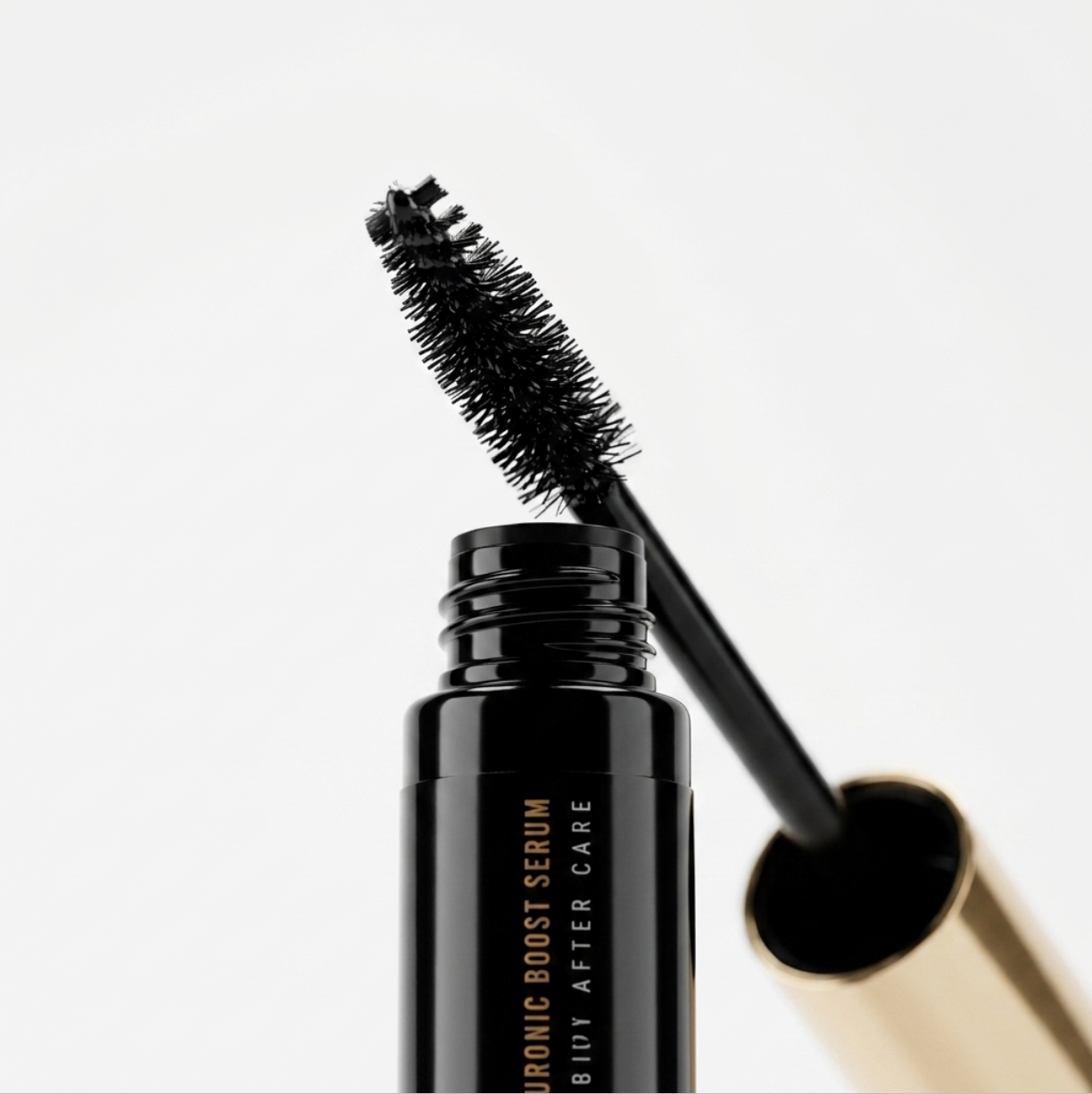 Close-up view of the applicator spoolie showing the lightweight, hydrating Elleeplex Hyaluronic Boost Serum formula.